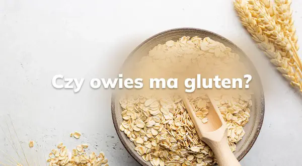 Miseczka płatków owsianych i kłosy zbóż. Pytanie "Czy owies ma gluten?" sugeruje dyskusję o jego zawartości.